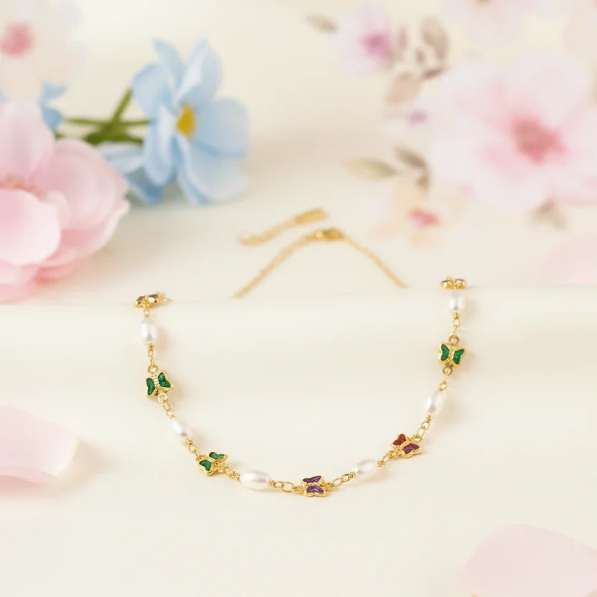 Gold bracelet with floral designs on a soft floral background