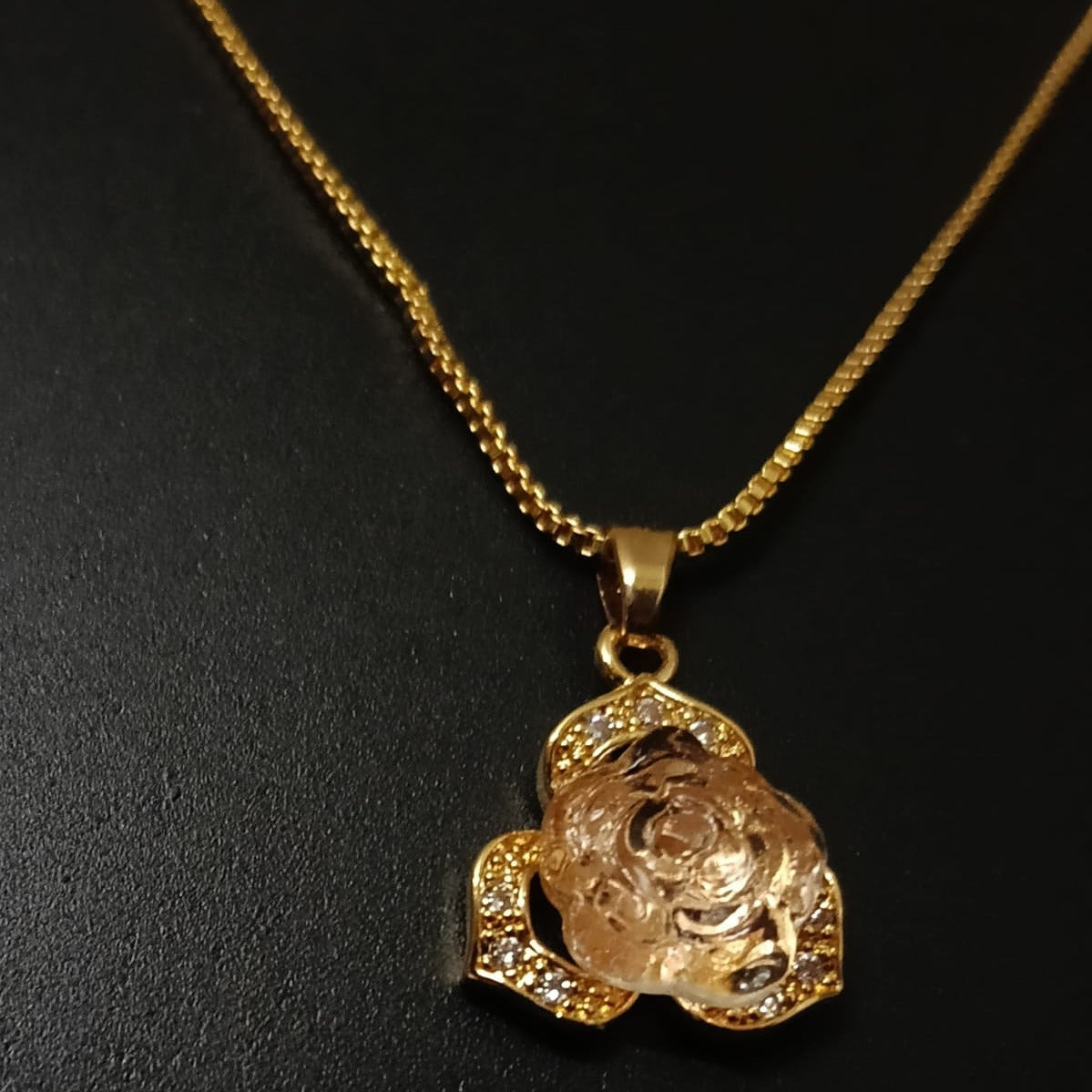 Gold necklace with a rose-shaped pendant