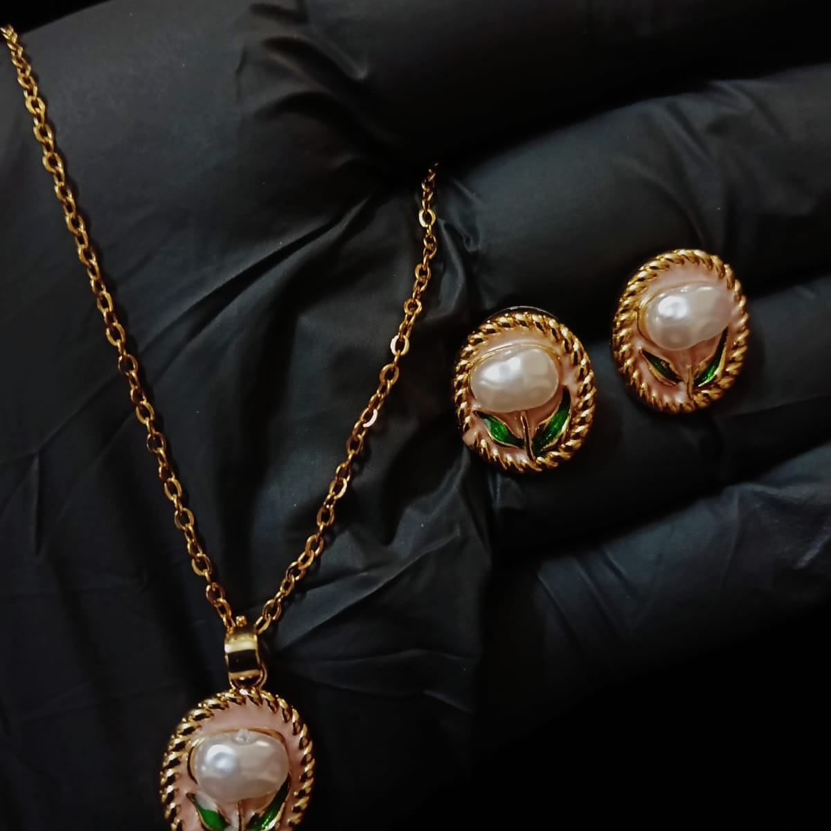 Gold necklace and earrings with pearl-like stones