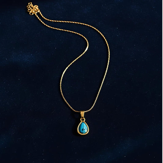 Gold necklace with a turquoise pendant  