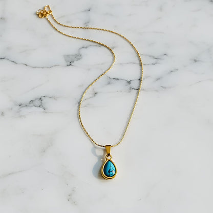 Gold necklace with a turquoise pendant  