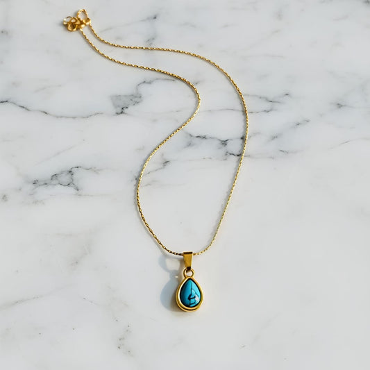 Gold necklace with a turquoise pendant  