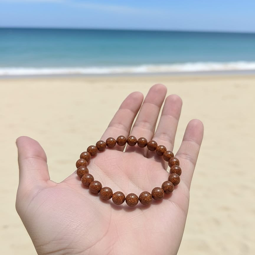 Brown beaded bracelet on a hand