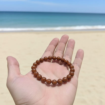 Brown beaded bracelet on a hand