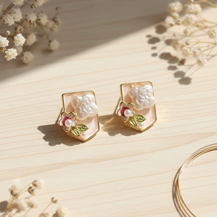 Pair of gold earrings with floral designs 
