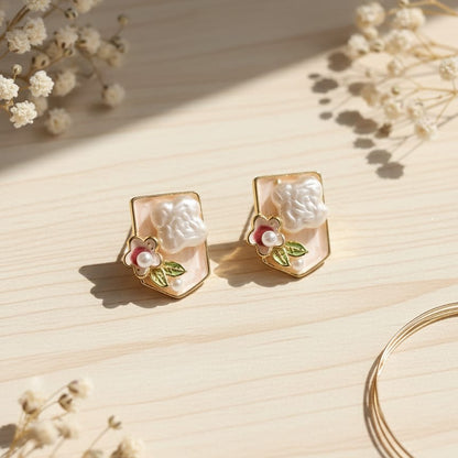 Pair of gold earrings with floral designs 