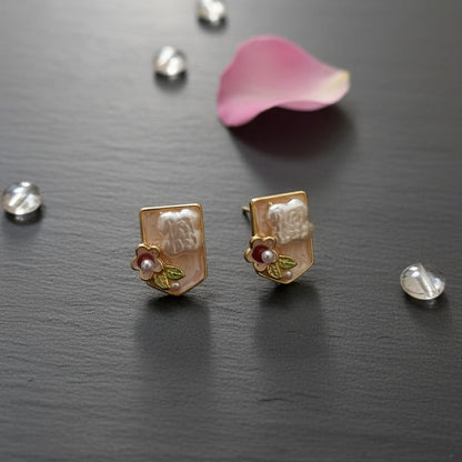 Pair of gold earrings with floral designs 