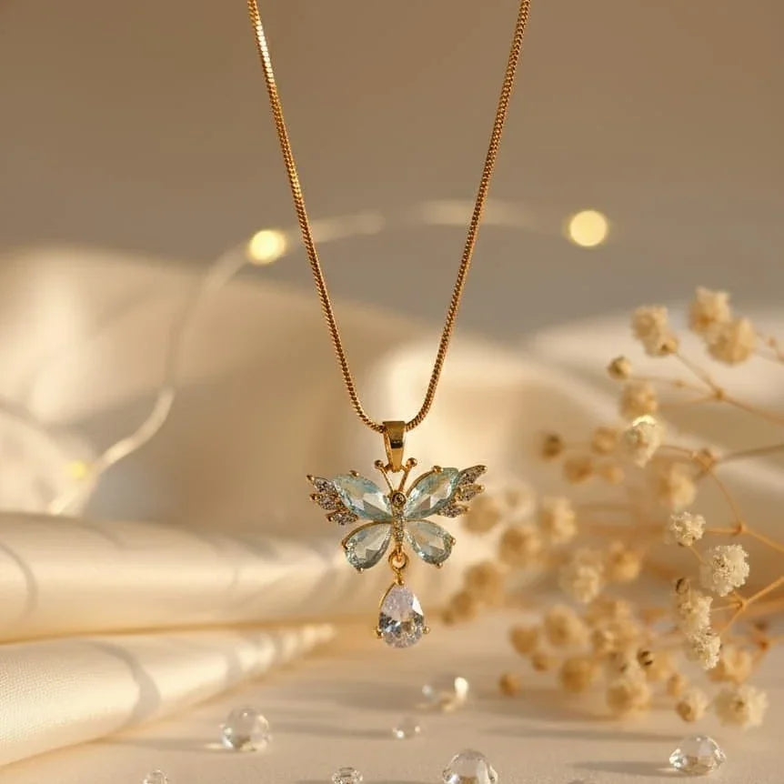 Gold necklace with a butterfly pendant on a soft beige background