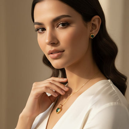 Woman wearing a necklace and earrings against a neutral background