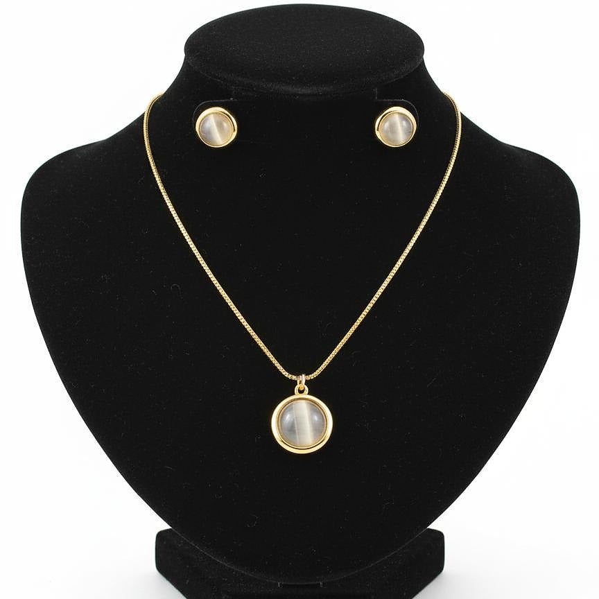 Jewelry set with necklace and earrings on a black stand