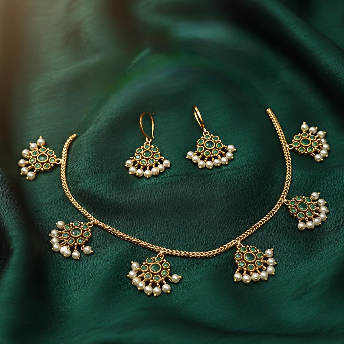 Gold necklace with green and pearl accents