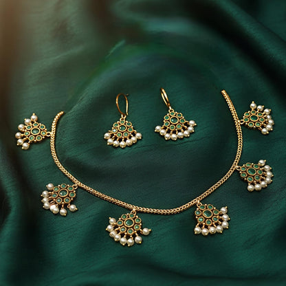 Gold necklace with green and pearl accents