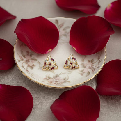 Gold earrings with red gemstones
