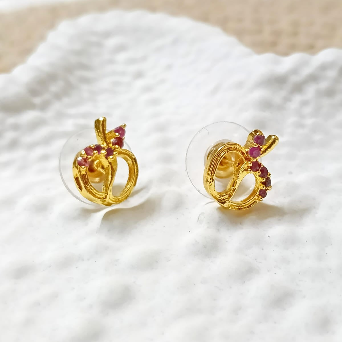 Gold earrings with red gemstones 