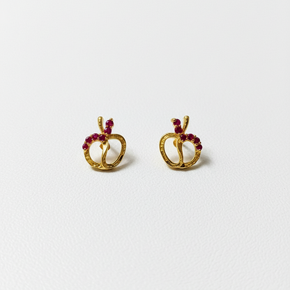 Gold earrings with red gemstones 