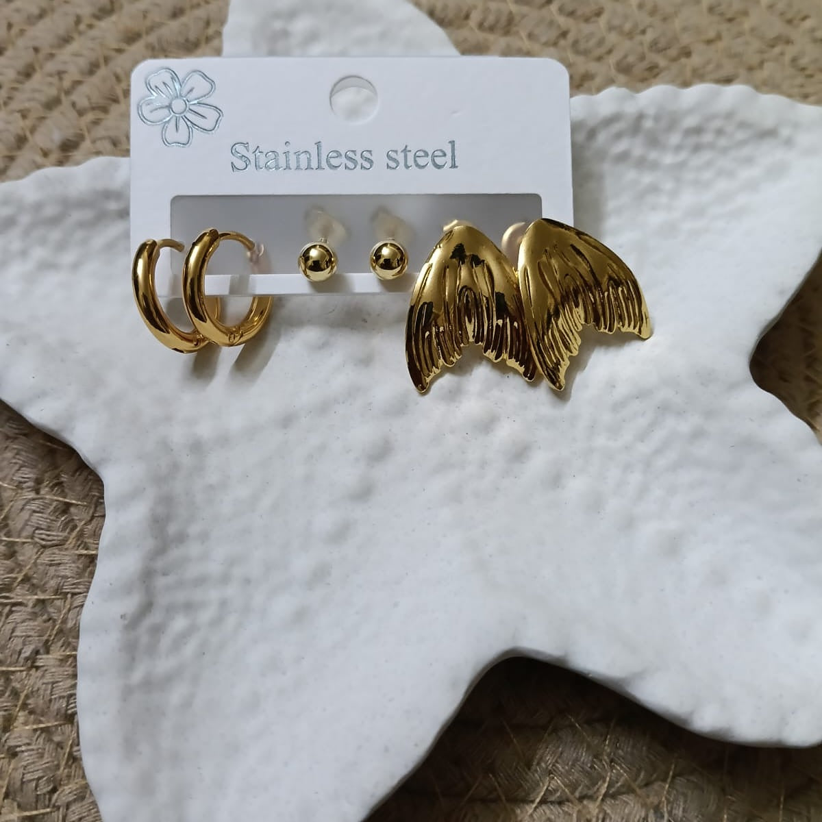 Gold hoop and wing-shaped earrings 