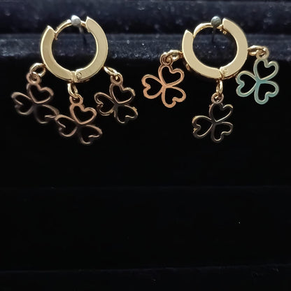 Gold hoop earrings with clover-shaped charms 