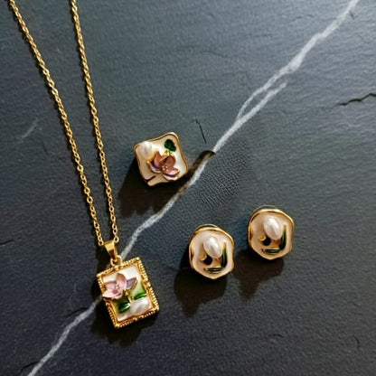 Gold necklace and earrings with floral designs