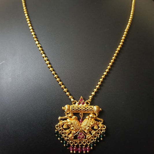 Gold necklace with a detailed pendant 

