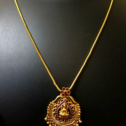 Gold necklace with a detailed pendant 