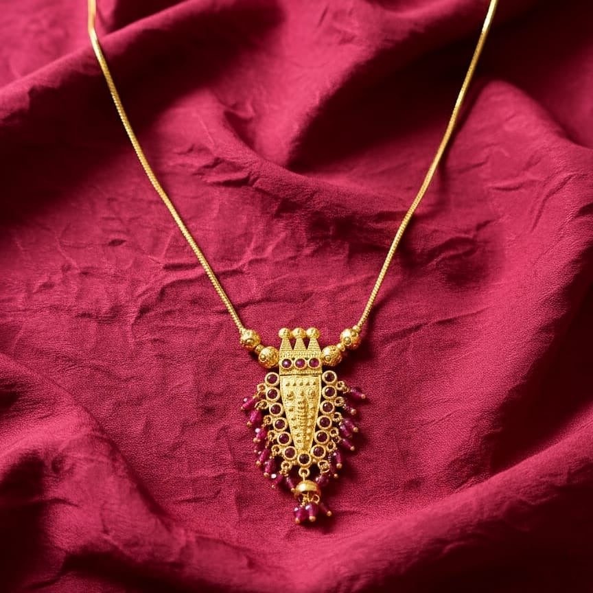 Gold necklace with a purple pendant 