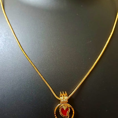 Gold necklace with a red pendant 