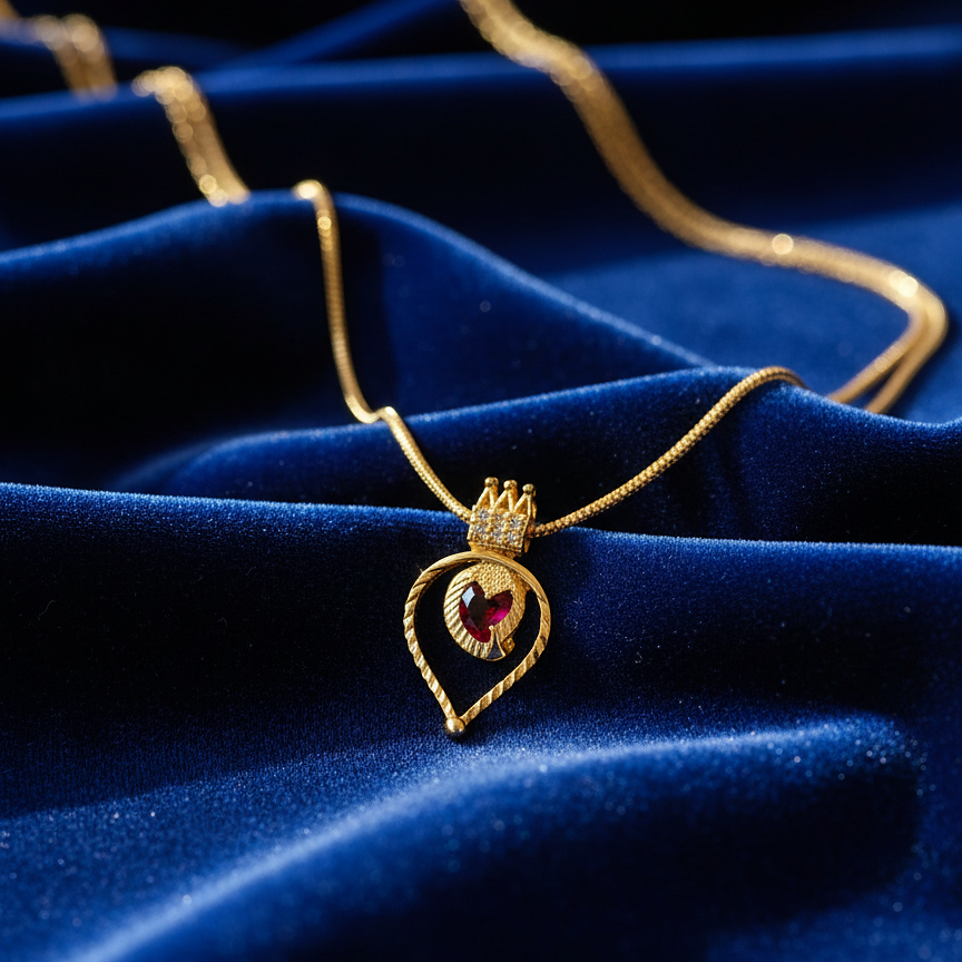 Gold necklace with a red pendant 