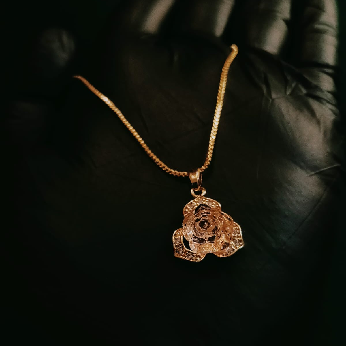 Gold necklace with a rose-shaped pendant