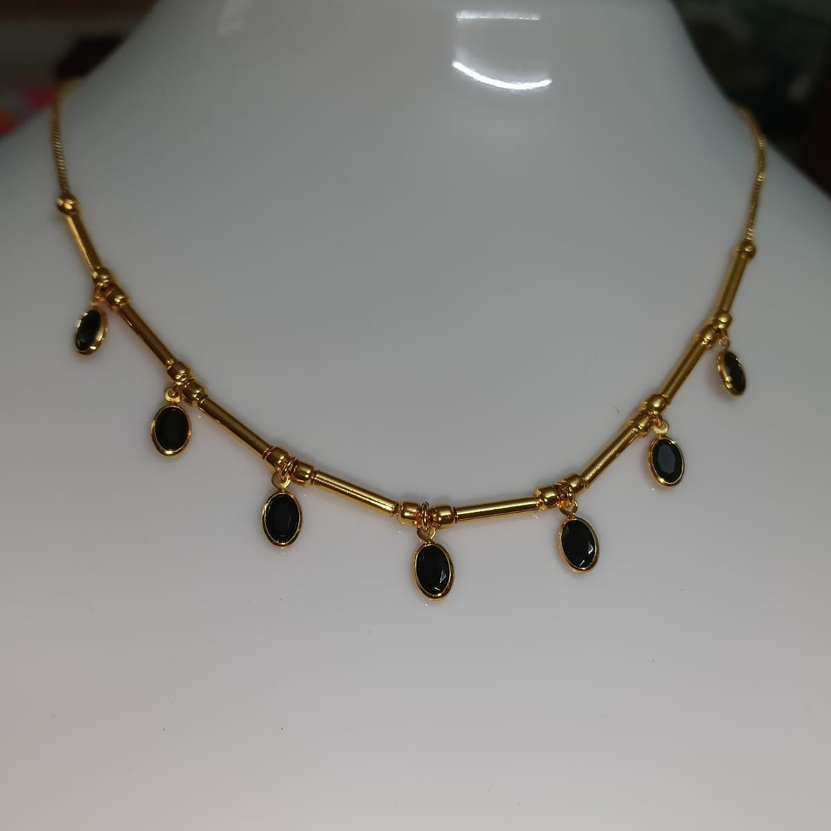 Gold necklace with black stones 