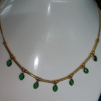 Gold necklace with green gemstones 