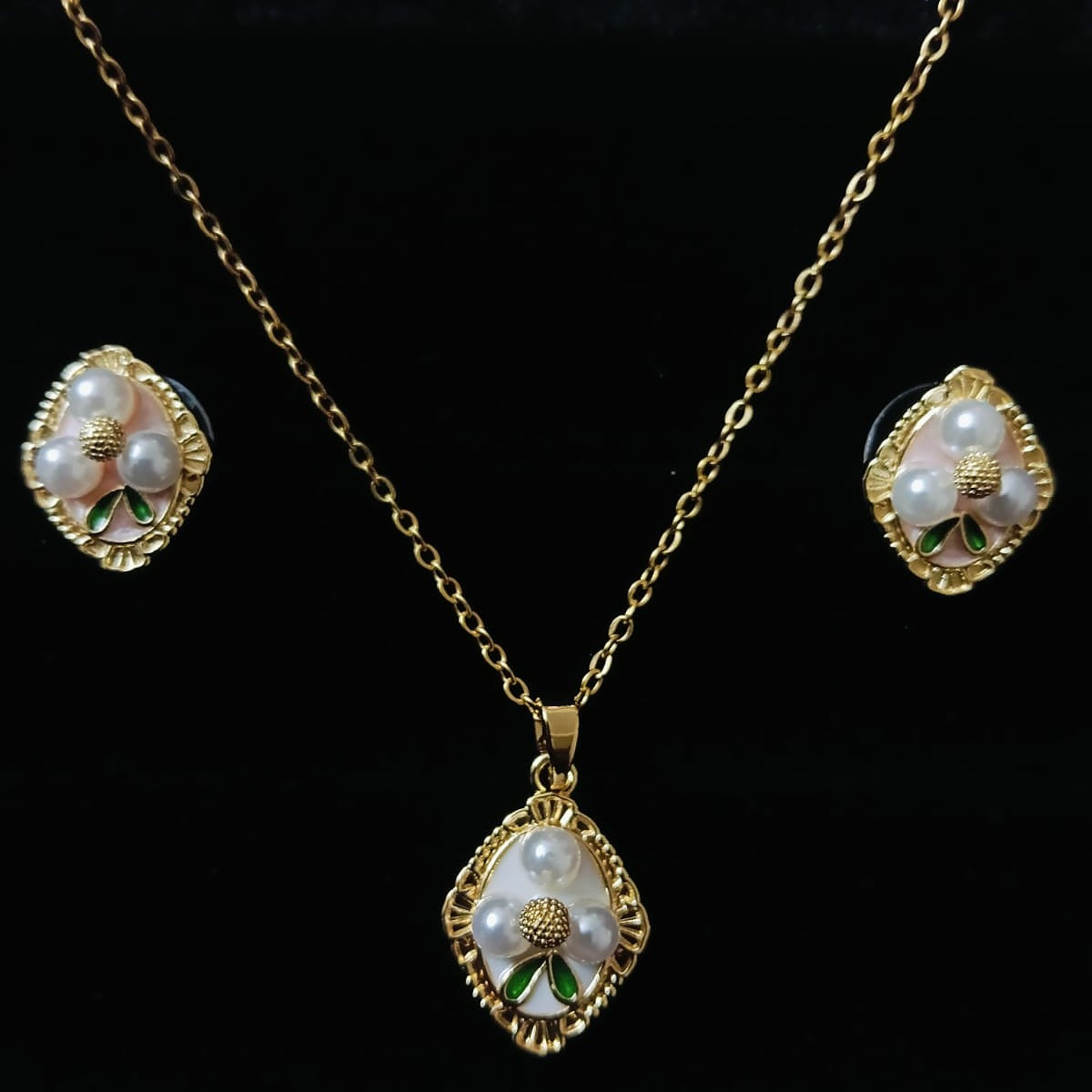 Gold necklace with pendant and matching earrings