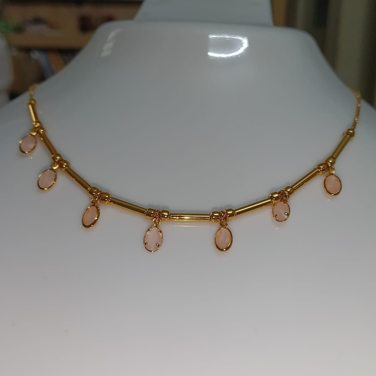 Gold necklace with pink stones 