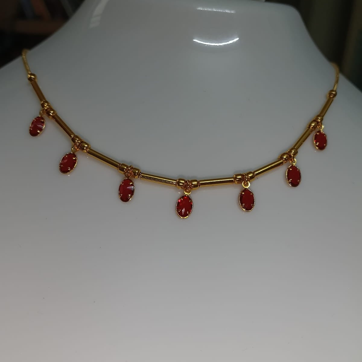 Gold necklace with red stones
