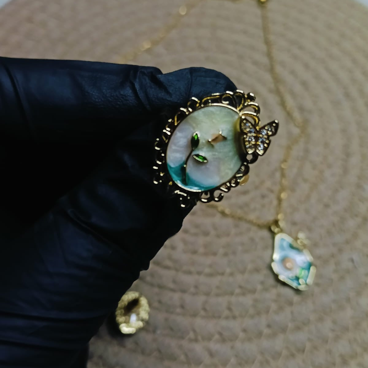 Gold ring with a green gemstone 