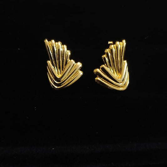 Pair of gold earrings on a black background