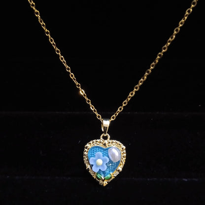 Heart-shaped pendant with floral design on a gold chain