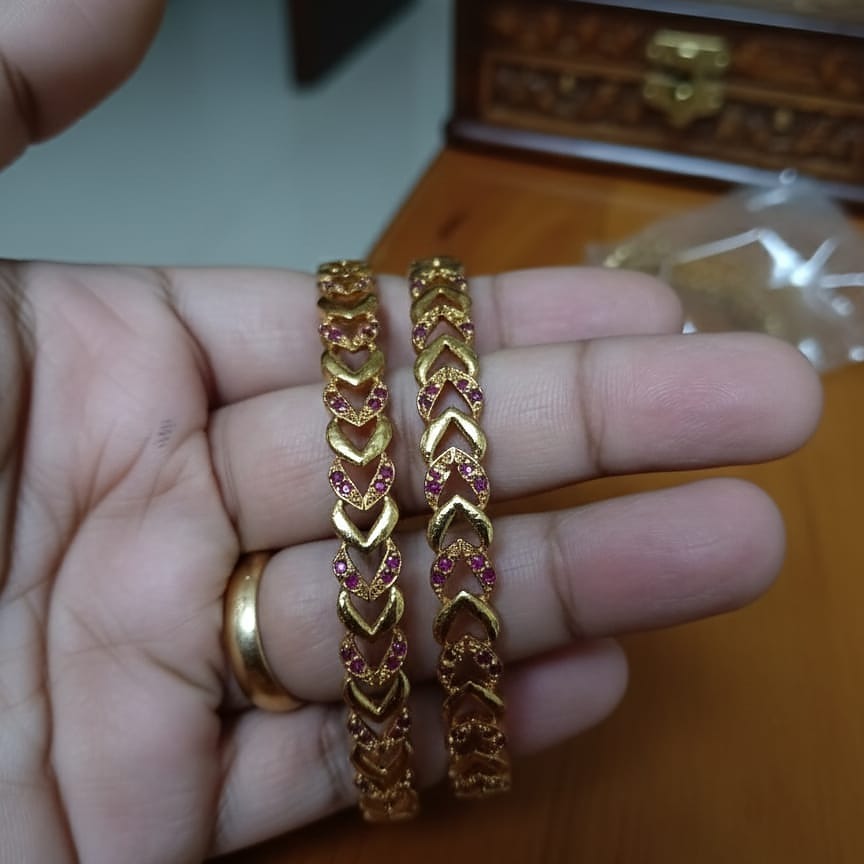 Intricately Carved Gold-Toned Bangle Set with Red/Ruby Accent Stones