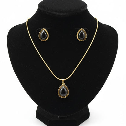 Jewelry set with necklace and earrings on a black stand