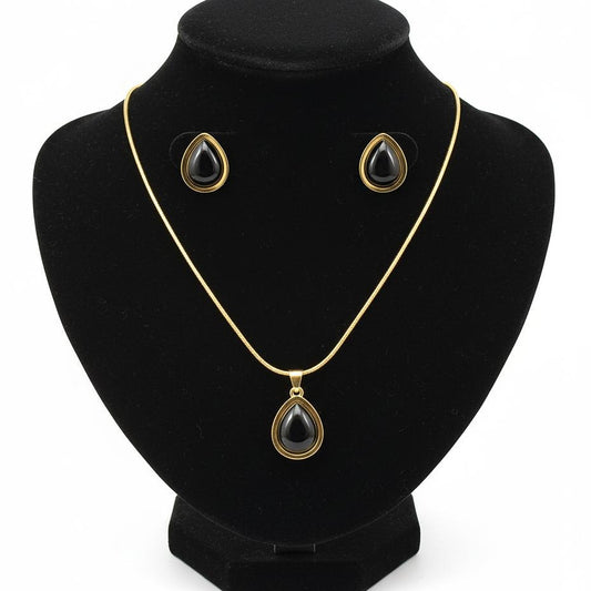 Jewelry set with necklace and earrings on a black stand