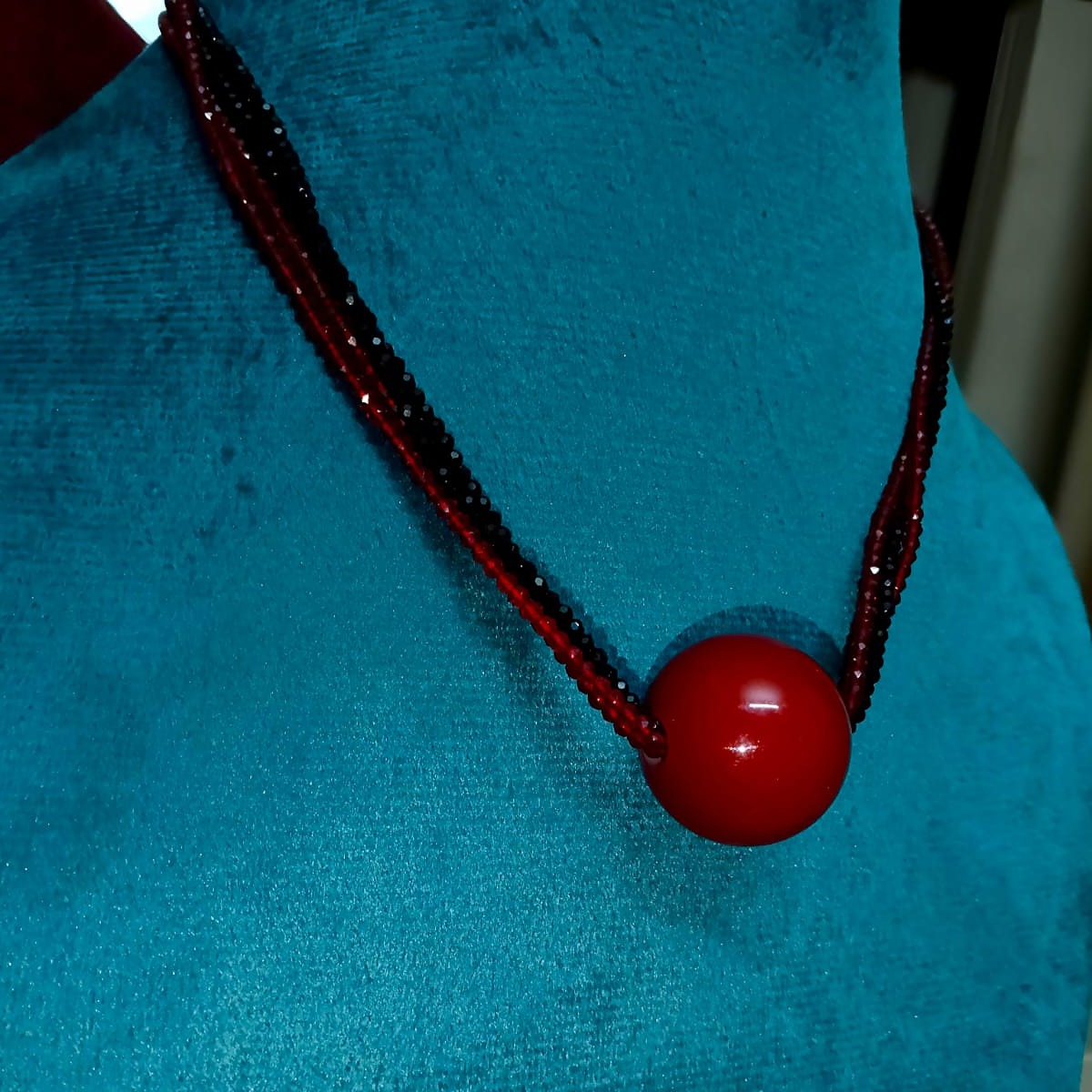 Necklace with a red bead