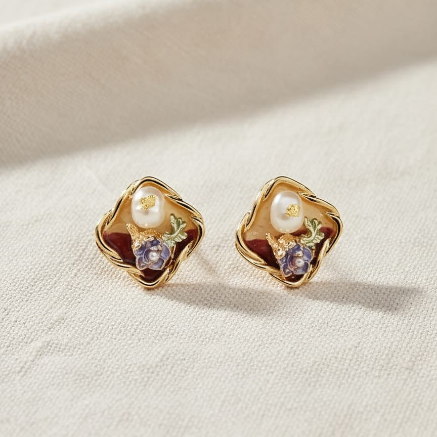 Pair of gold earrings with pearls and floral designs