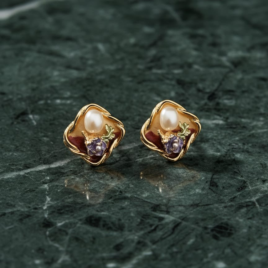 Pair of gold earrings with pearls and purple stones