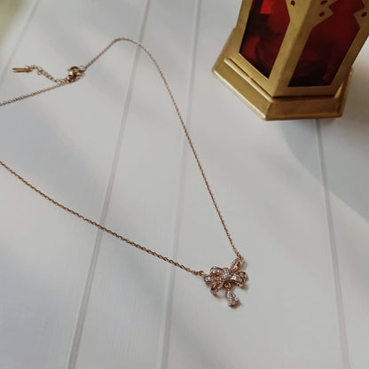 Rose gold necklace with a bow pendant 