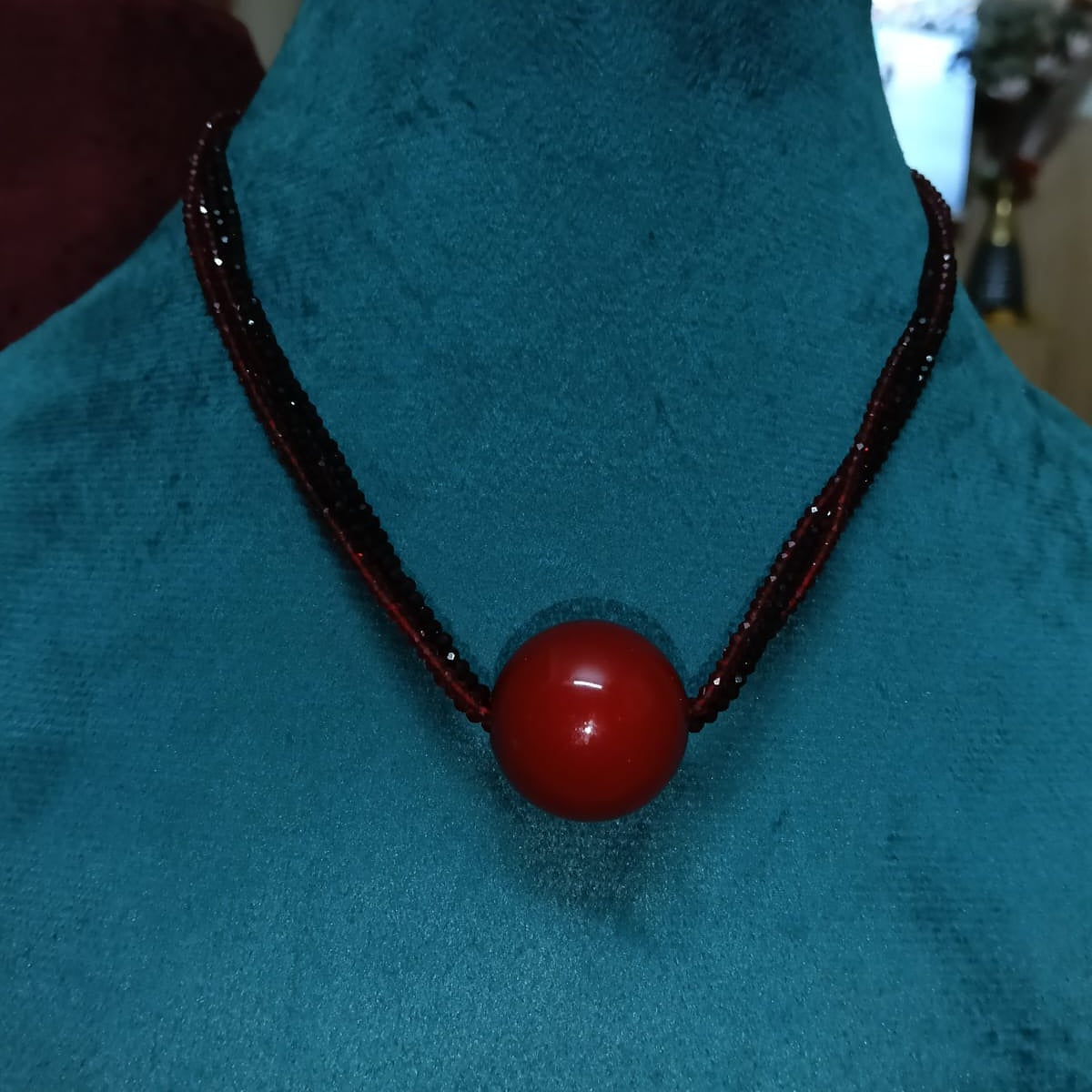 Necklace with a red bead 