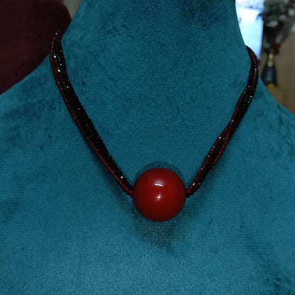 Necklace with a red bead 