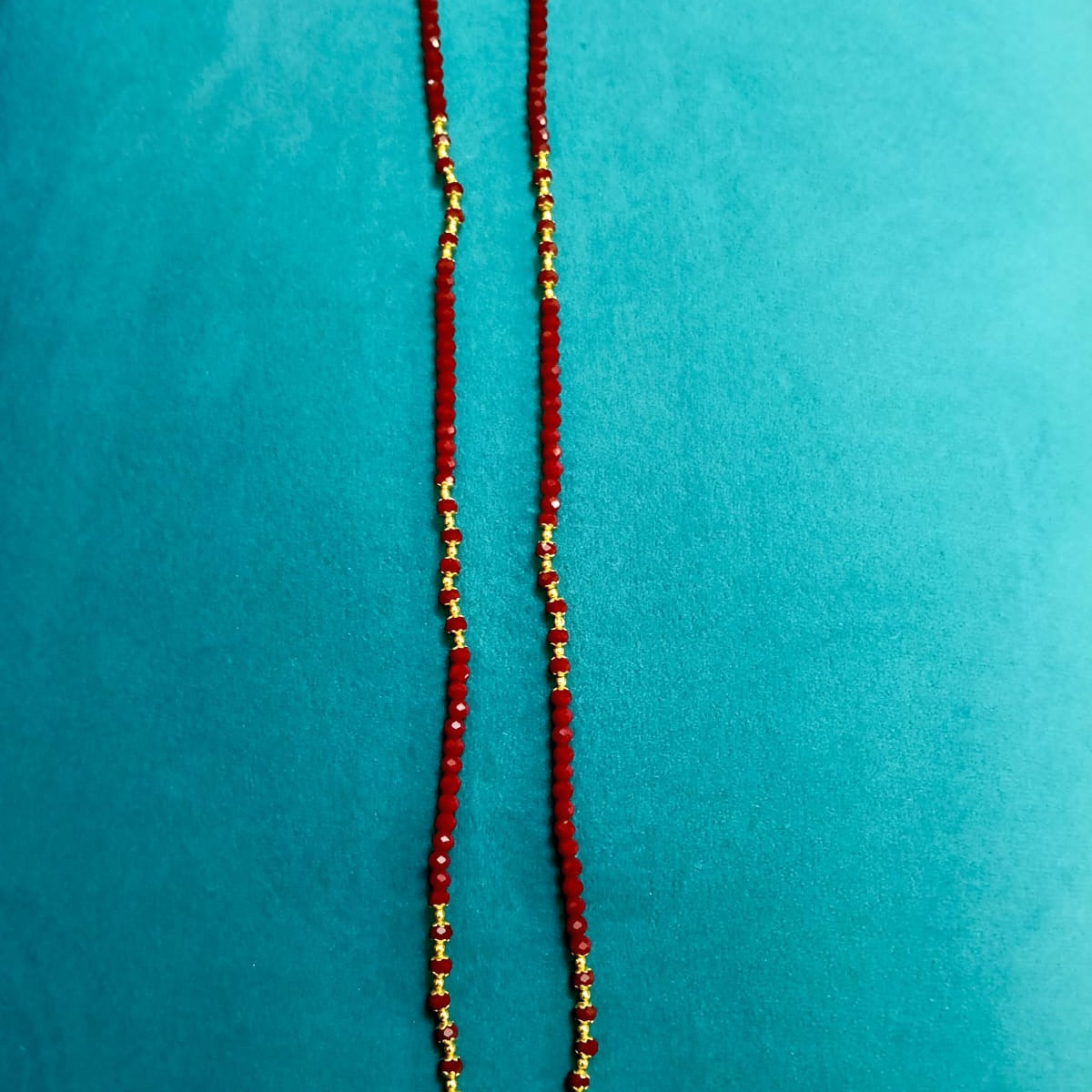 Red beaded necklace with gold accents 