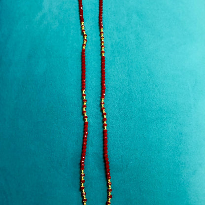 Red beaded necklace with gold accents 