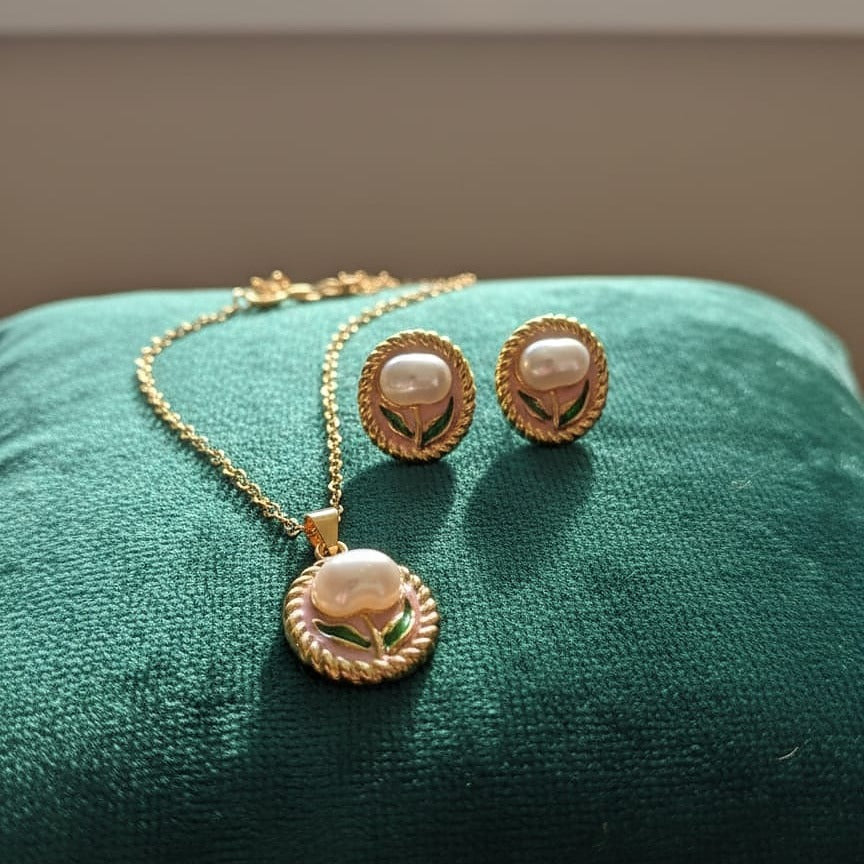 Gold necklace and earrings with pearl-like centers  
