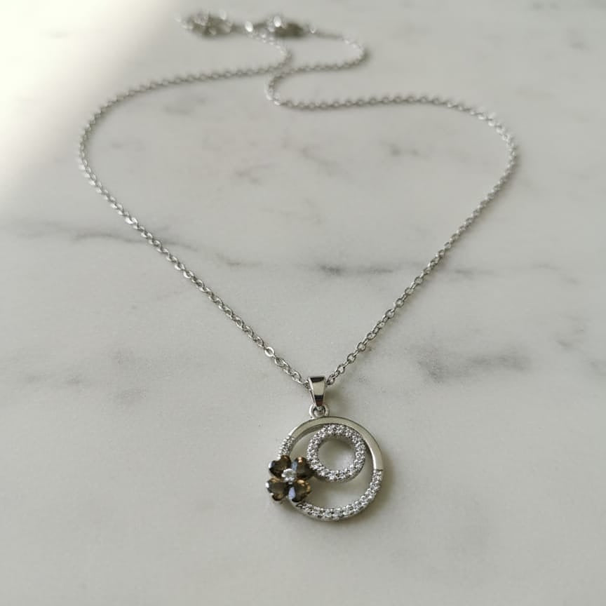 Silver necklace with a circular pendant 
