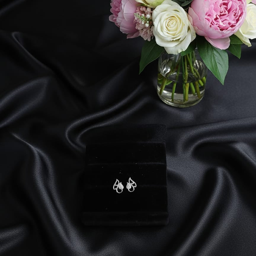 silver pair of earrings 